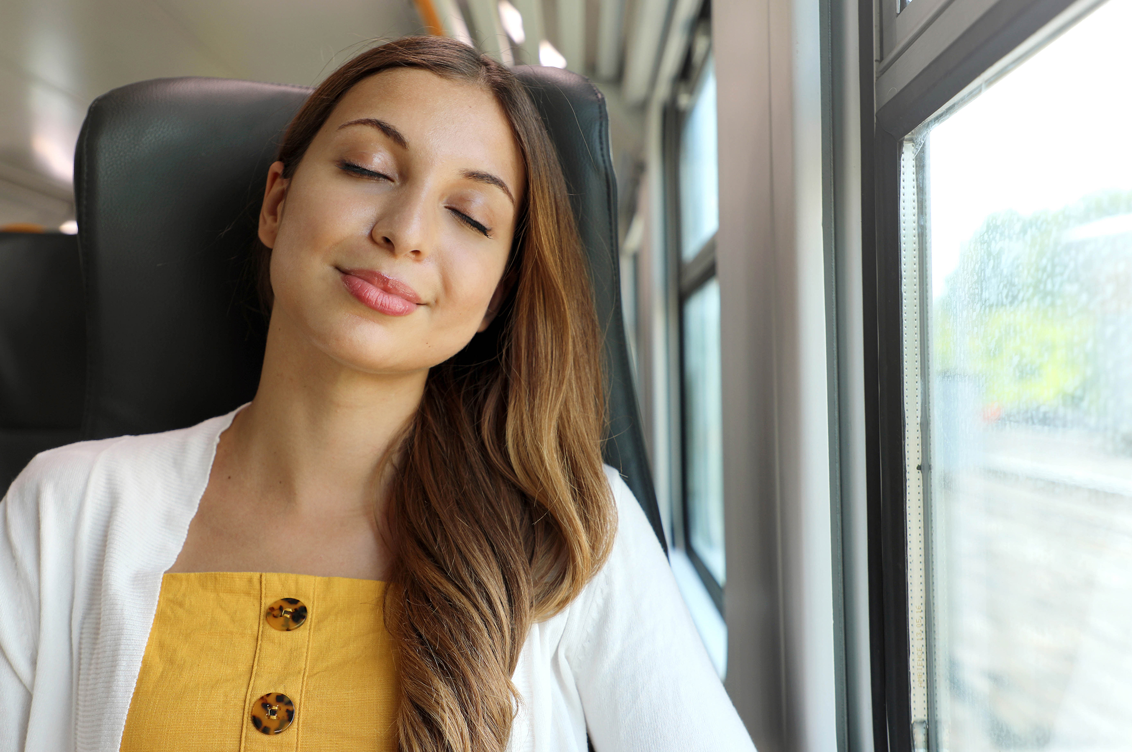 Tired business woman sleeping sitting in the train after a day o